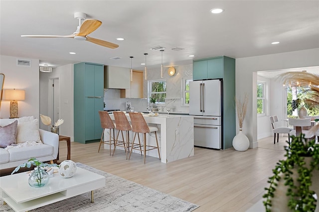 living room with ceiling fan and light wood-type flooring