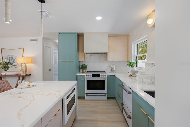 kitchen featuring decorative backsplash, light stone counters, custom range hood, built in microwave, and range