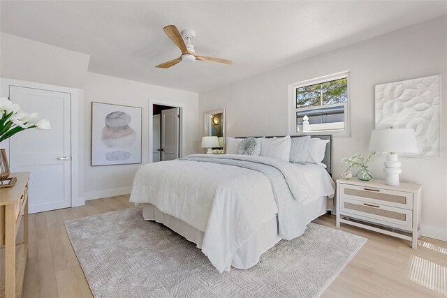 bedroom with ceiling fan and light hardwood / wood-style floors