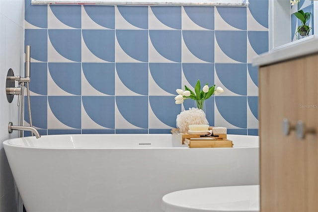 bathroom featuring a bathing tub, toilet, and tile walls