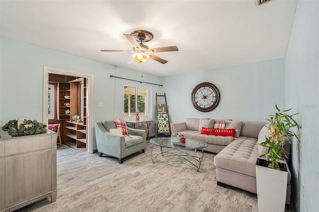 living room featuring ceiling fan and light wood-type flooring