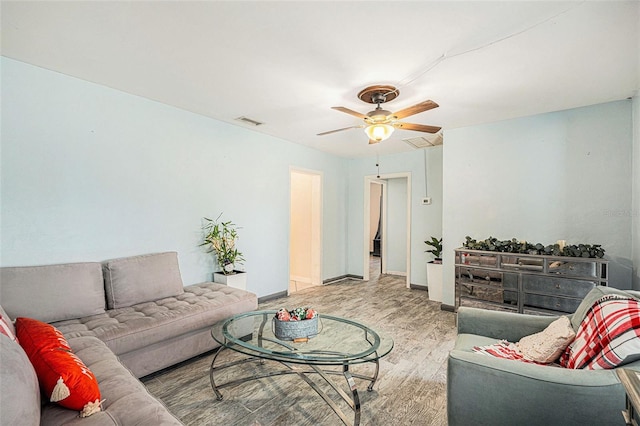 living room with hardwood / wood-style floors and ceiling fan