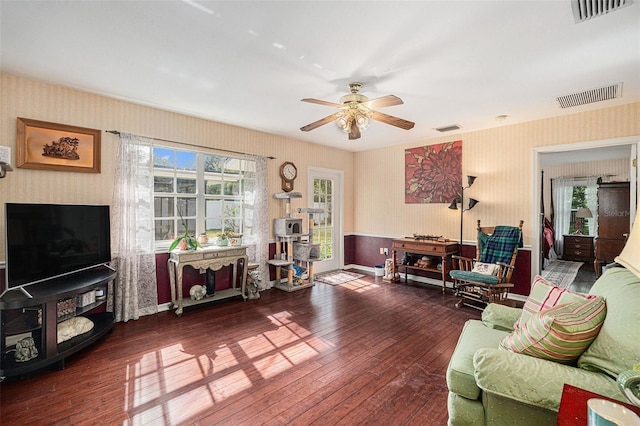 living room with ceiling fan and dark hardwood / wood-style flooring