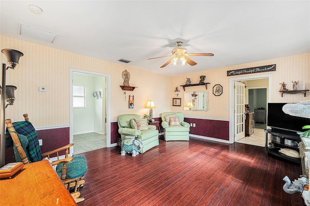 living room with dark hardwood / wood-style floors and ceiling fan