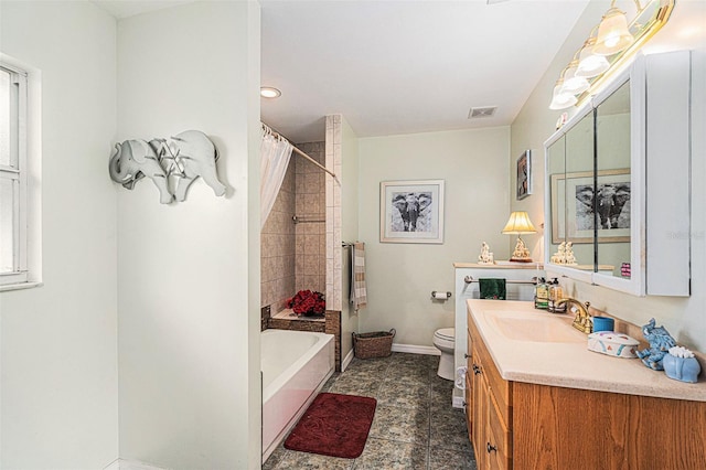 bathroom featuring a washtub, toilet, and vanity