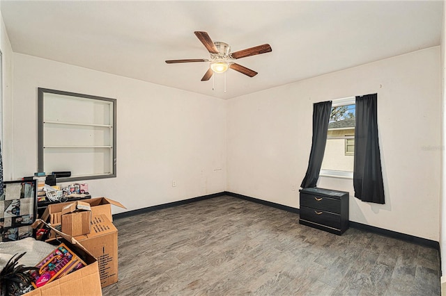 unfurnished room featuring ceiling fan and dark hardwood / wood-style flooring