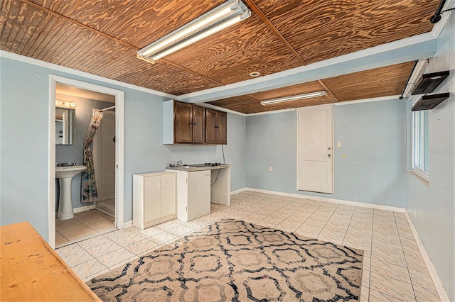 basement featuring wooden ceiling and sink