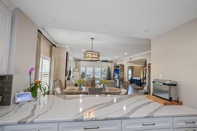 kitchen featuring hardwood / wood-style flooring, white cabinetry, and a healthy amount of sunlight