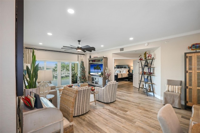 living room featuring ceiling fan, light hardwood / wood-style floors, and ornamental molding