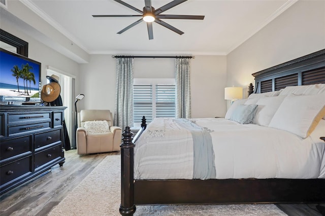 bedroom with ceiling fan, crown molding, and hardwood / wood-style flooring