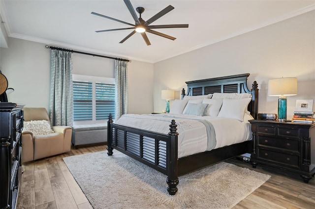 bedroom featuring hardwood / wood-style flooring, ceiling fan, and ornamental molding