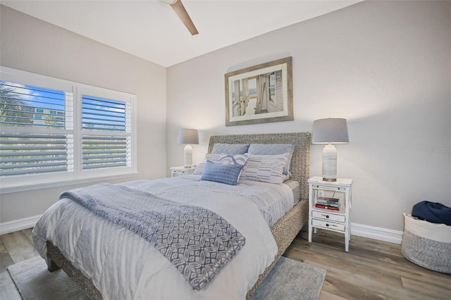 bedroom with ceiling fan and wood-type flooring