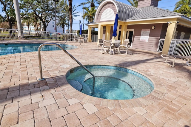 view of pool with a patio area and a community hot tub