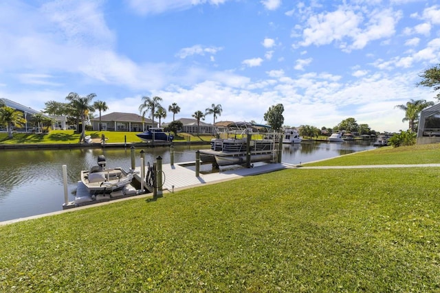 view of dock featuring a water view and a yard