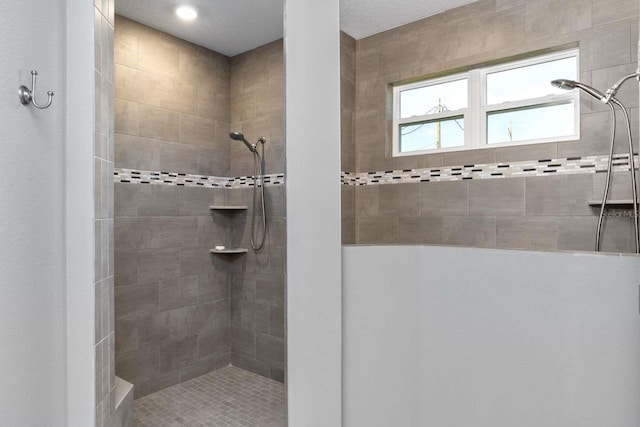 bathroom with a tile shower