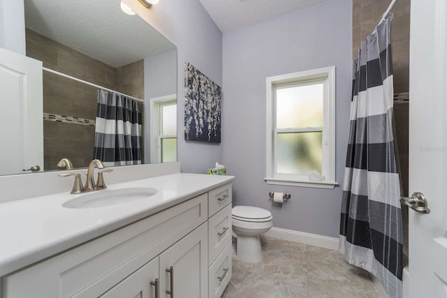 bathroom with walk in shower, vanity, a textured ceiling, and toilet