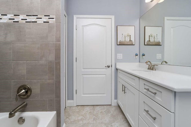 bathroom with tile patterned floors, vanity, and tiled shower / bath combo