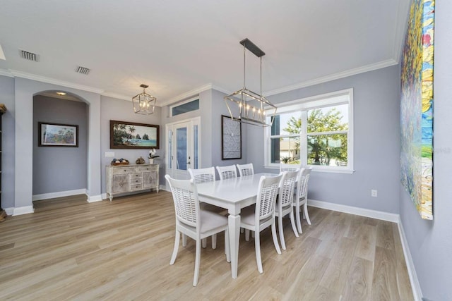 15 Cold Spring Ct, Palm Coast, FL 32137 - dining space featuring a chandelier, light wood-style floors, baseboards, and ornamental molding