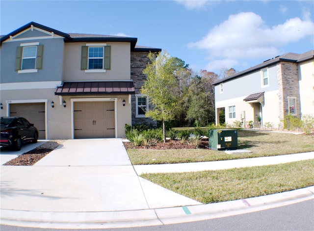 view of front of home with a front yard and a garage