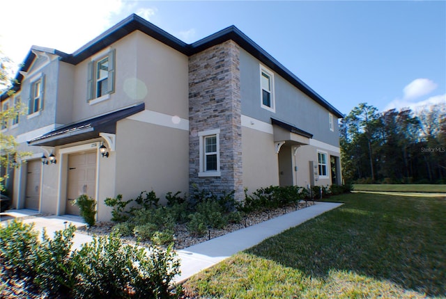 view of side of property with a yard and a garage