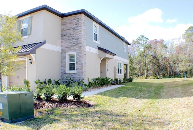 view of front of home featuring a garage and a front yard