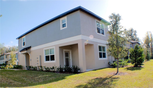 view of side of home with a lawn