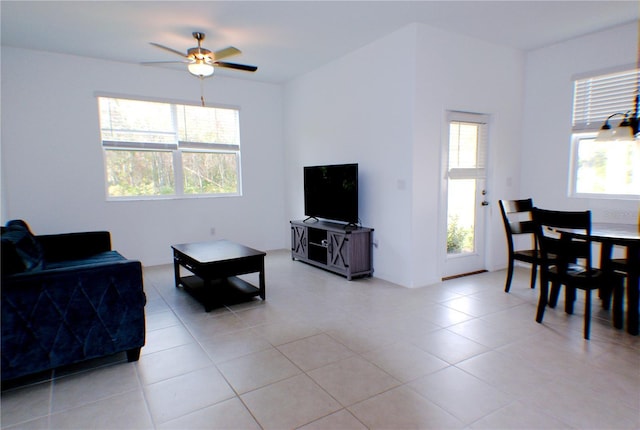 tiled living room with ceiling fan and a healthy amount of sunlight