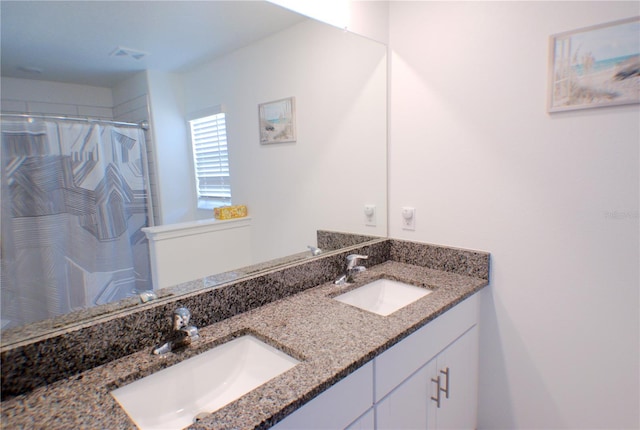 bathroom featuring vanity and curtained shower