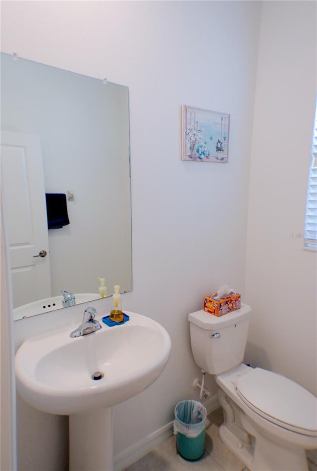 bathroom with tile patterned floors, sink, and toilet