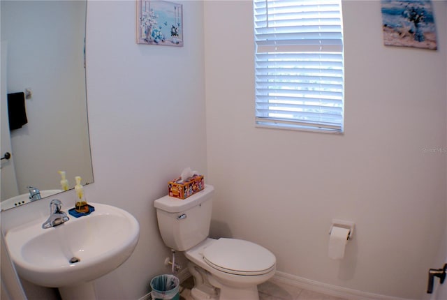 bathroom with tile patterned floors, toilet, and sink