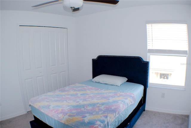 bedroom featuring multiple windows, ceiling fan, and a closet