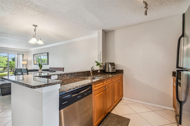 kitchen featuring dark stone countertops, kitchen peninsula, a textured ceiling, and appliances with stainless steel finishes