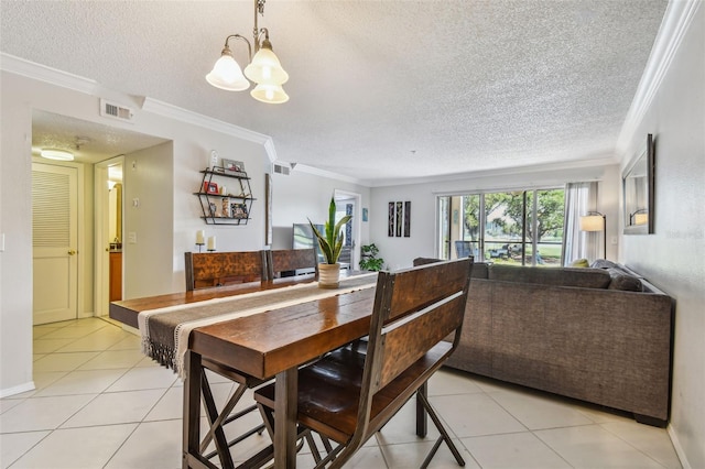 dining room featuring light tile patterned floors, a textured ceiling, an inviting chandelier, and ornamental molding