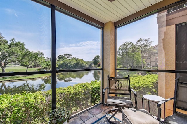 sunroom / solarium with a water view