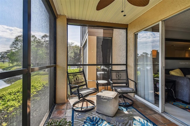 sunroom featuring ceiling fan and wood ceiling