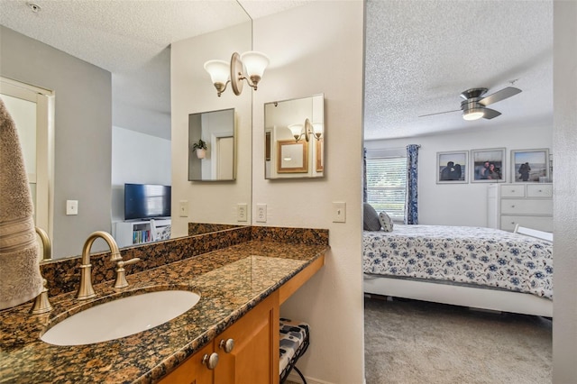 bathroom with vanity, a textured ceiling, and ceiling fan