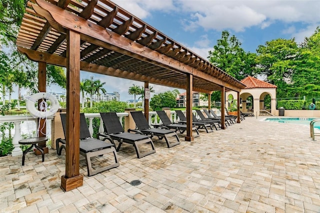 view of community with a pergola, a pool, and a patio area