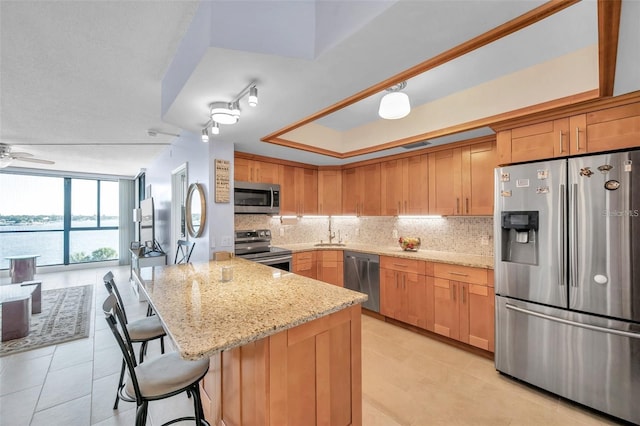 kitchen with decorative backsplash, sink, light tile patterned flooring, and appliances with stainless steel finishes