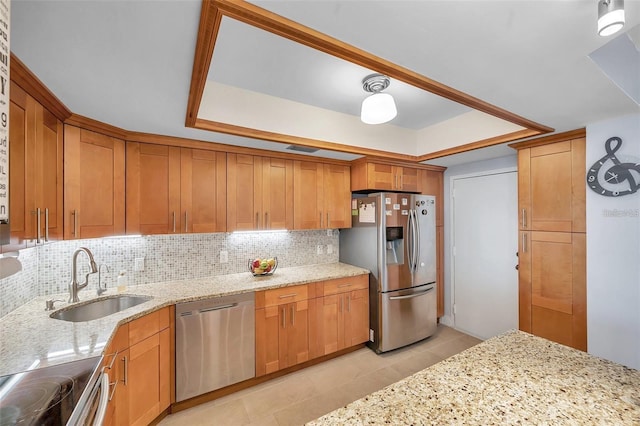 kitchen featuring sink, light tile patterned floors, appliances with stainless steel finishes, tasteful backsplash, and light stone counters