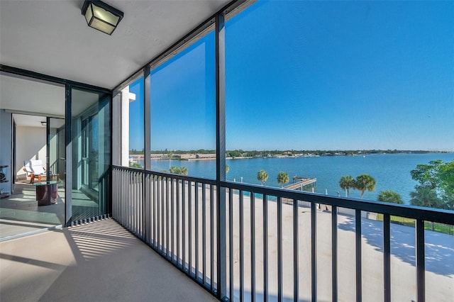 unfurnished sunroom with a water view