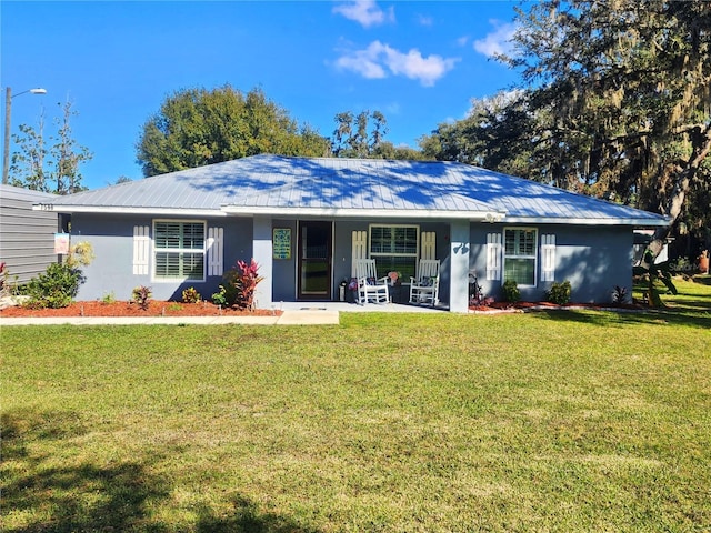 ranch-style house with covered porch and a front lawn