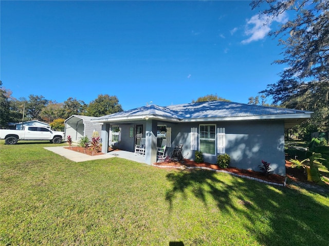 view of front of house with a front lawn and a carport