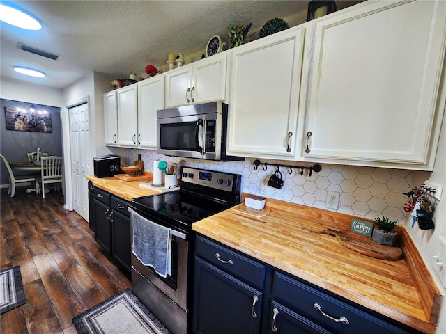 kitchen featuring wooden counters, stainless steel appliances, dark wood-type flooring, blue cabinetry, and white cabinetry