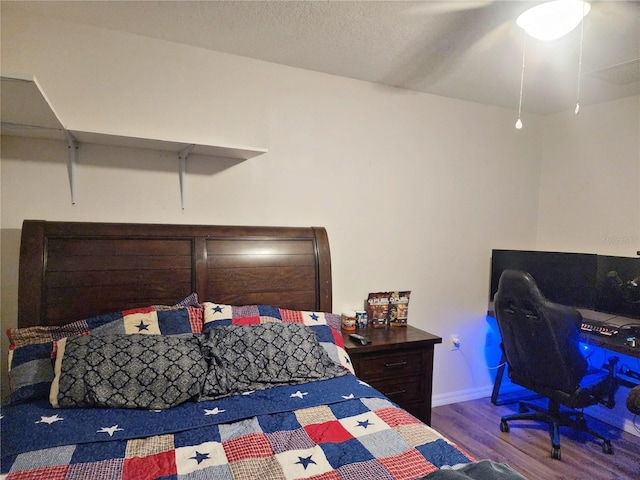 bedroom with hardwood / wood-style flooring