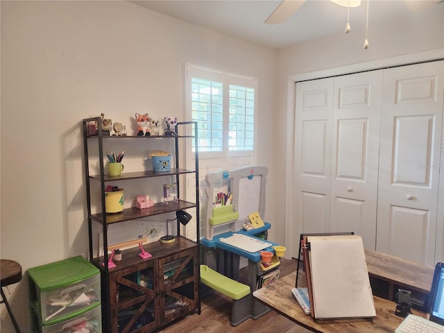 home office with wood-type flooring and ceiling fan