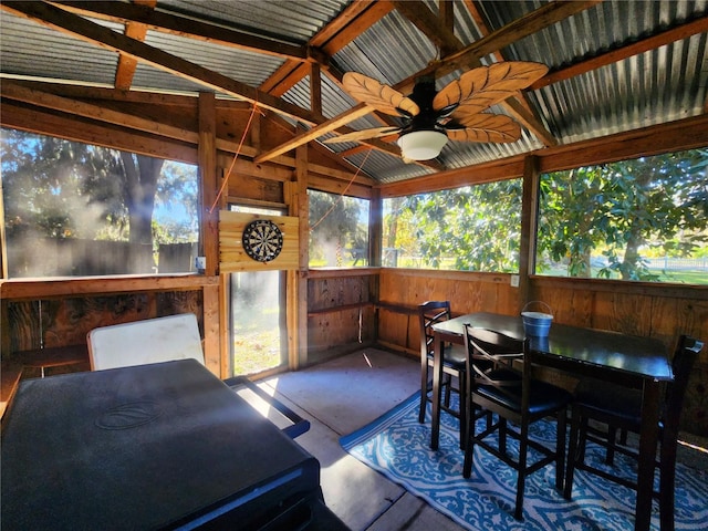 sunroom with lofted ceiling with beams and ceiling fan