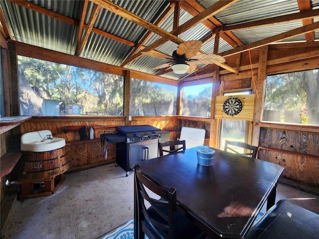 sunroom / solarium featuring lofted ceiling with beams, ceiling fan, and a wealth of natural light