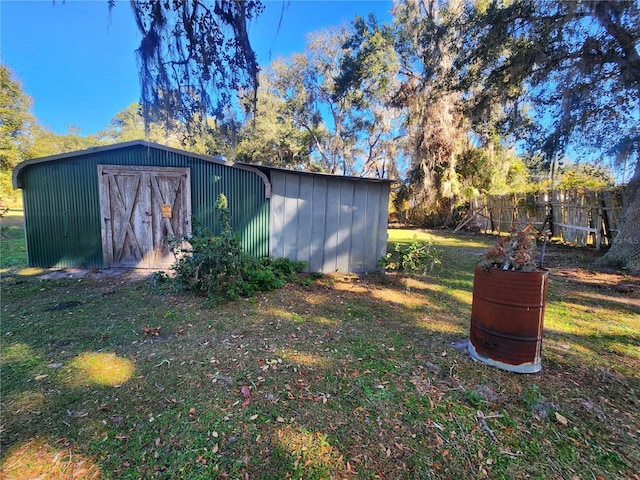 view of outbuilding featuring a yard