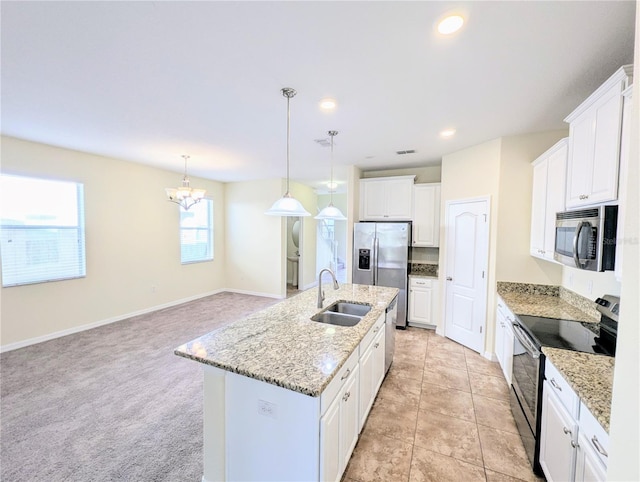 kitchen featuring a kitchen island with sink, hanging light fixtures, sink, appliances with stainless steel finishes, and white cabinetry