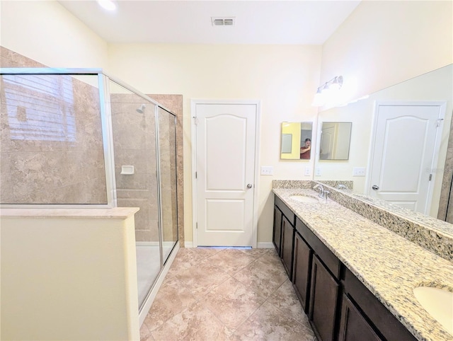 bathroom featuring vanity and a shower with shower door